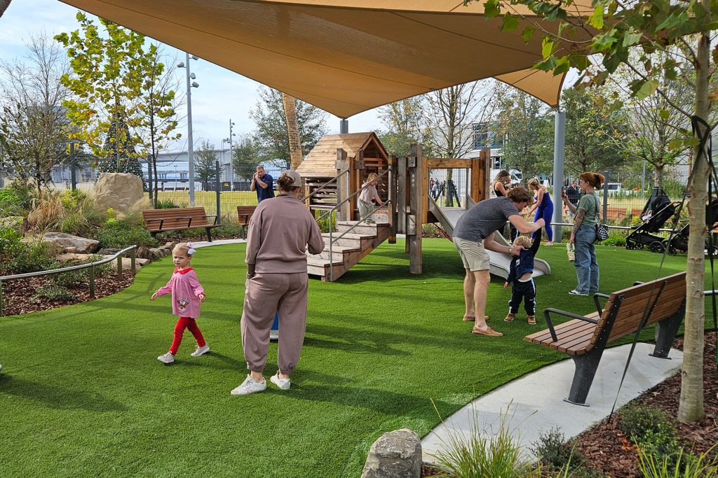 Families explore the new riverfront playground.