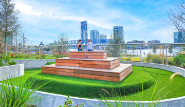 Residents take in the view from atop the playground, where a raised photo-taking platform offers sweeping views of Downtown backdrops.