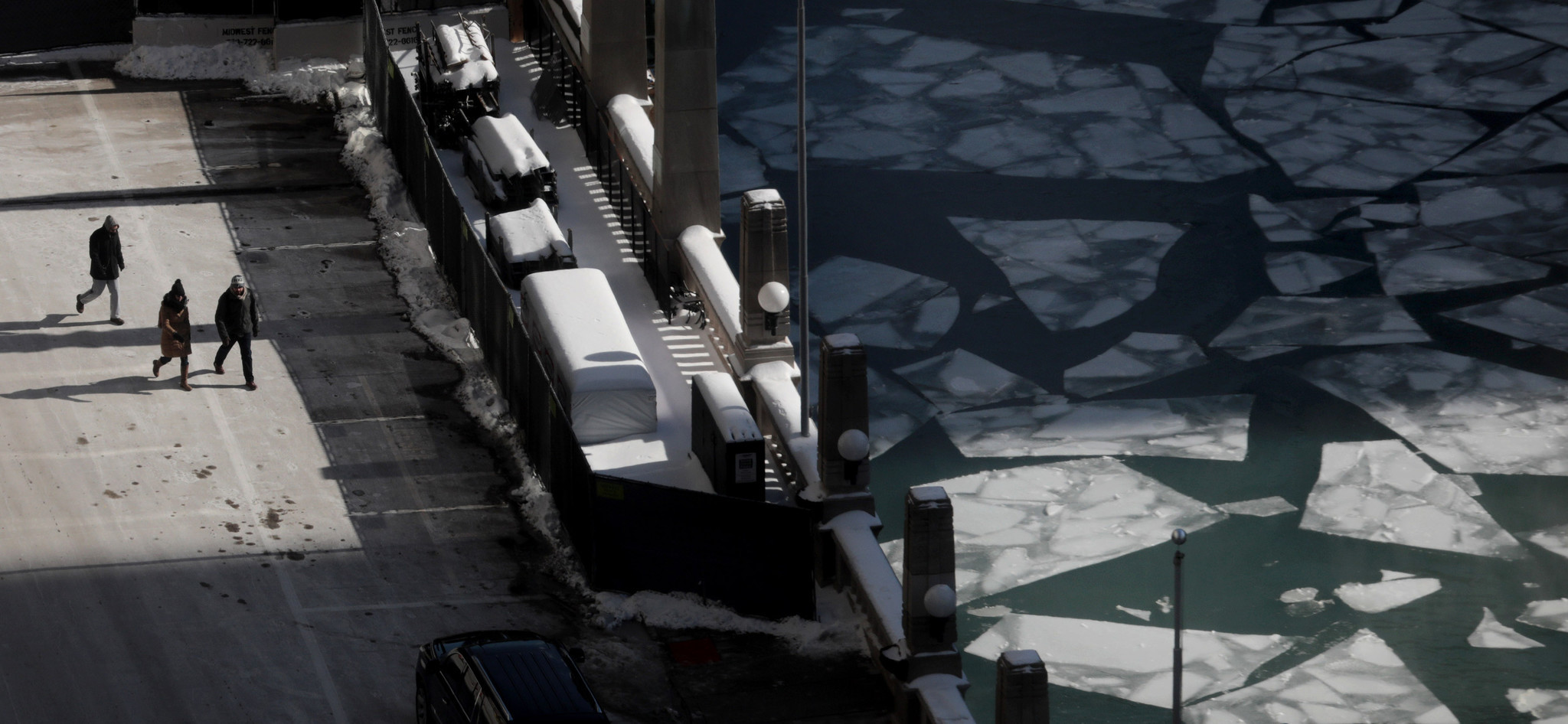 People walks toward the icy Chicago River near Merchandise Mart...