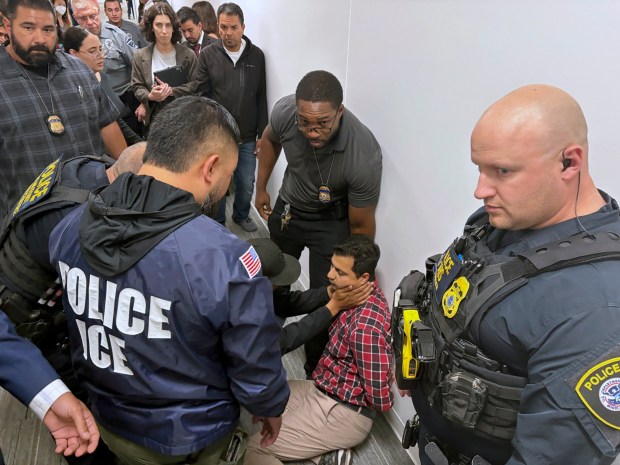 A man doesn't feel well when ICE attempted to arrest him. U.S. Immigration and Customs Enforcement (ICE) conducted multiple arrests outside the immigration court in San Diego, detaining at least five individuals. Some were handcuffed immediately in the courthouse hallway, drawing concern from witnesses. At least one person appeared to suffer a medical issue during the attempted arrest, prompting further alarm among onlookers. (Photo by Michael Ho Wai Lee / SOPA Images/Sipa USA)(Sipa via AP Images)