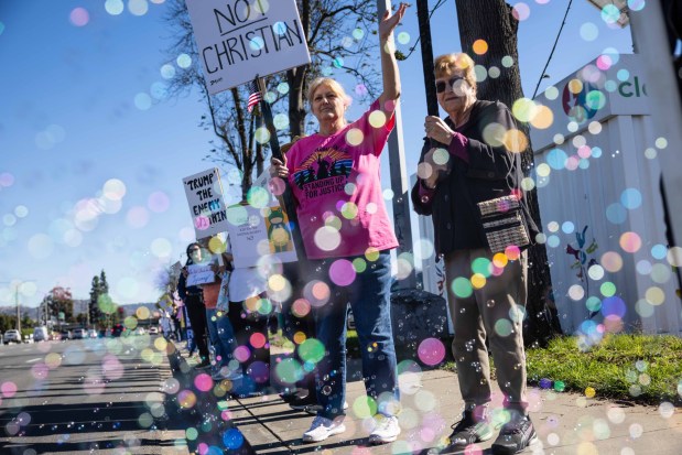 From left, Nacny Chiquete and Lois Knowlton protest the killing of Renee Good and the policies of the Trump administration on Saturday, Jan. 10, 2026 in El Cajon, CA. (Zoë Meyers / For The San Diego Union-Tribune)