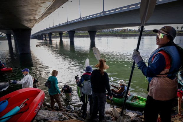 Volunteers prepare to board their kayaks to pick-up trash along the San Diego River Estuary on Saturday, January 17, 2026. About 200 volunteers helped clean trash out of the estuary which was put on by The San Diego River Park Foundation. (Sandy Huffaker / For The San Diego Union-Tribune)