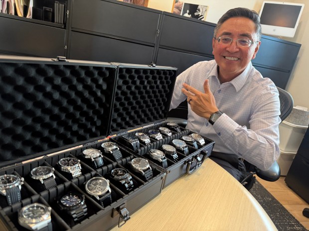 Bennett Peji, executive director of the local chapter of the American Institute of Architects, with his collection of wristwatches that he has made. (Roger Showley)