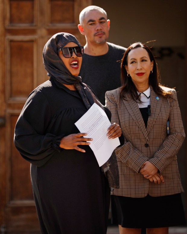 Samsam Khalif, a child care provider, left, along with Councilmember Sean Elo-Rivera and Supervisor Paloma Aguirre, attended a news conference to condemn recent harassment of Somali child care workers at the United Domestic Workers (UDW) office on Jan. 8, 2026, in San Diego. (K.C. Alfred / The San Diego Union-Tribune)