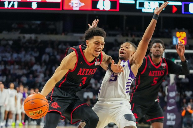 San Diego State's Elzie Harrington pushes past Grand Canyon's Brian Moore Jr. during Wednesday's 70-69 Grand Canyon win at GCU Arena in Phoenix, Ariz. (Darryl Webb, for The San Diego Union-Tribune)