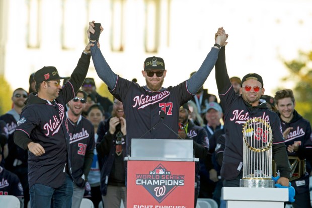 FILE - Washington Nationals pitcher and World Series MVP Stephen Strasburg, center, celebrates the World Series baseball championship during a rally following a parade to celebrate the team's World Series baseball championship over Houston Astros, in Washington, Nov. 2, 2019.  (AP Photo/Jose Luis Magana, File)