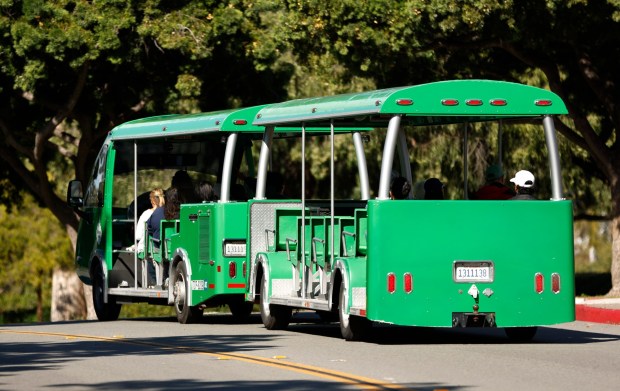 Visitors ride on the free Balboa Park tram on the first day of paid parking throughout the park on Monday, Jan. 5, 2026, in San Diego. (K.C. Alfred / The San Diego Union-Tribune)