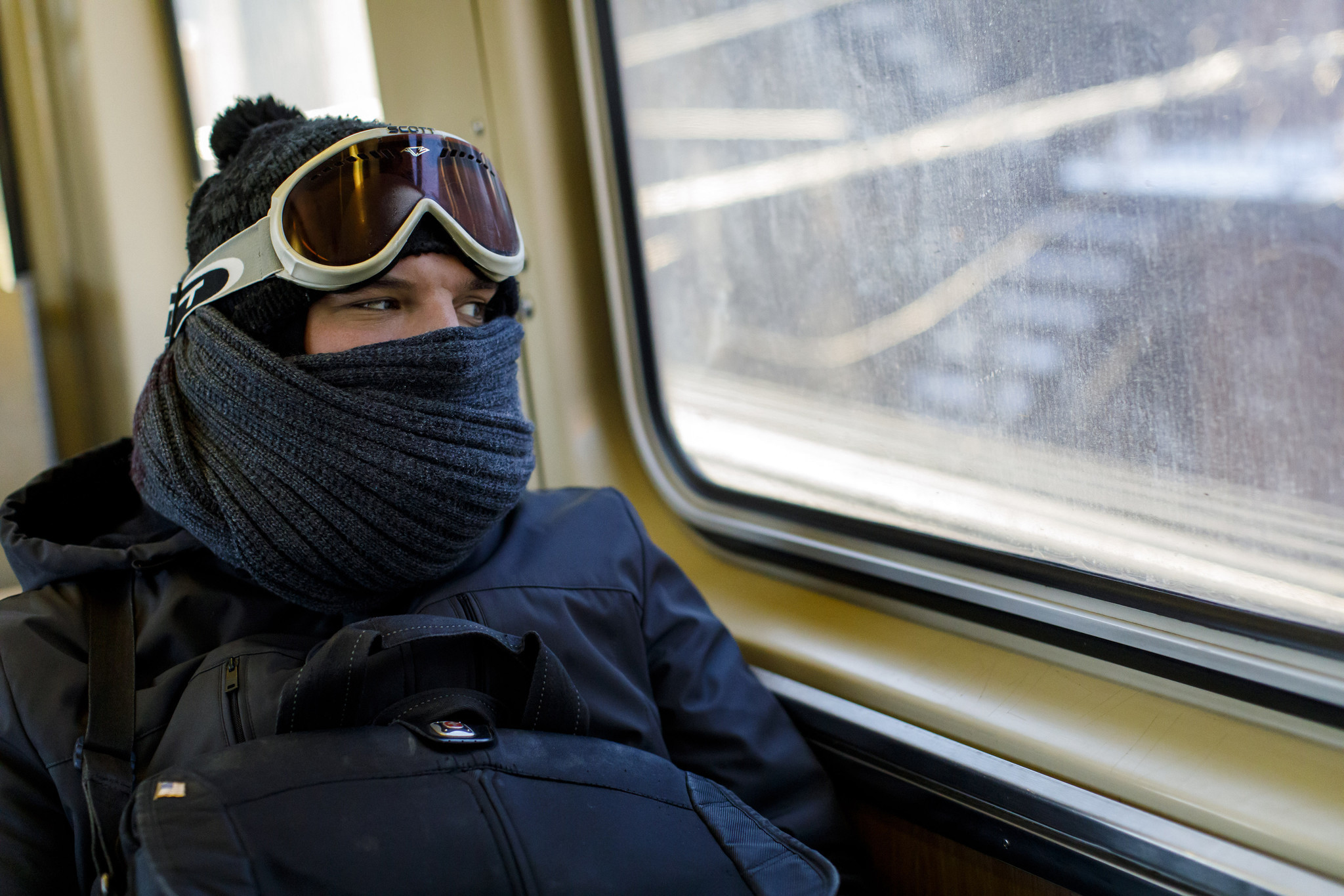 A man rides the CTA Blue Line in below-zero temperatures...
