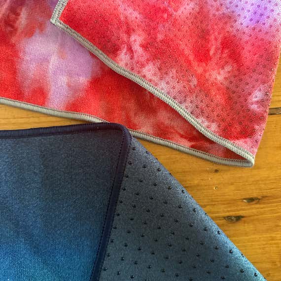 A close up view of the bottom of two different yoga mat towels.