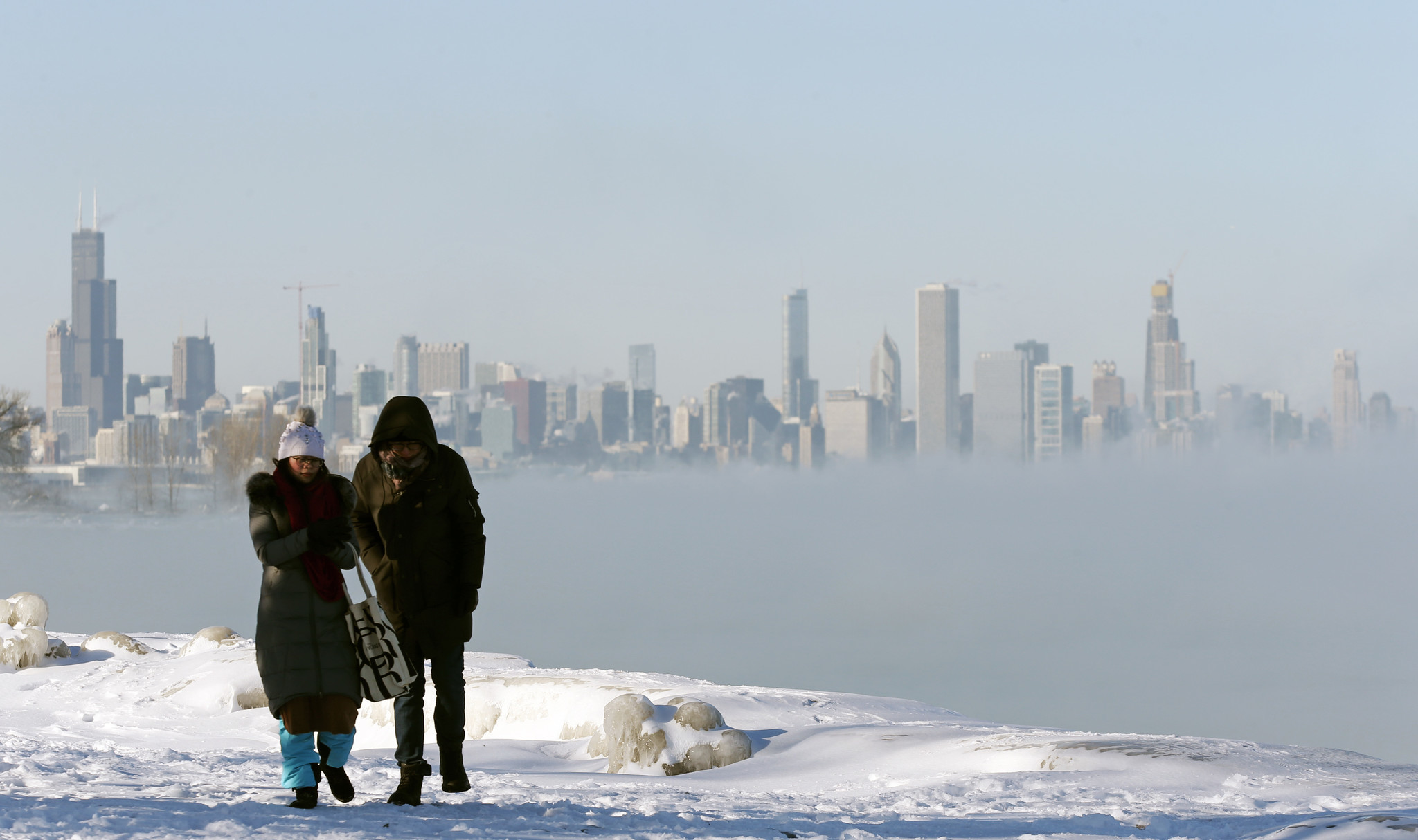 A woman and man walk along Promontory Point Wednesday, Jan....