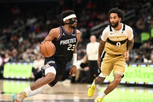 Dec 29, 2025; Washington, District of Columbia, USA; Phoenix Suns guard Jordan Goodwin (23) dribbles the ball in front of Washington Wizards forward Justin Champagnie (9) during the first quarter at Capital One Arena. Mandatory Credit: Rafael Suanes-Imagn Images
