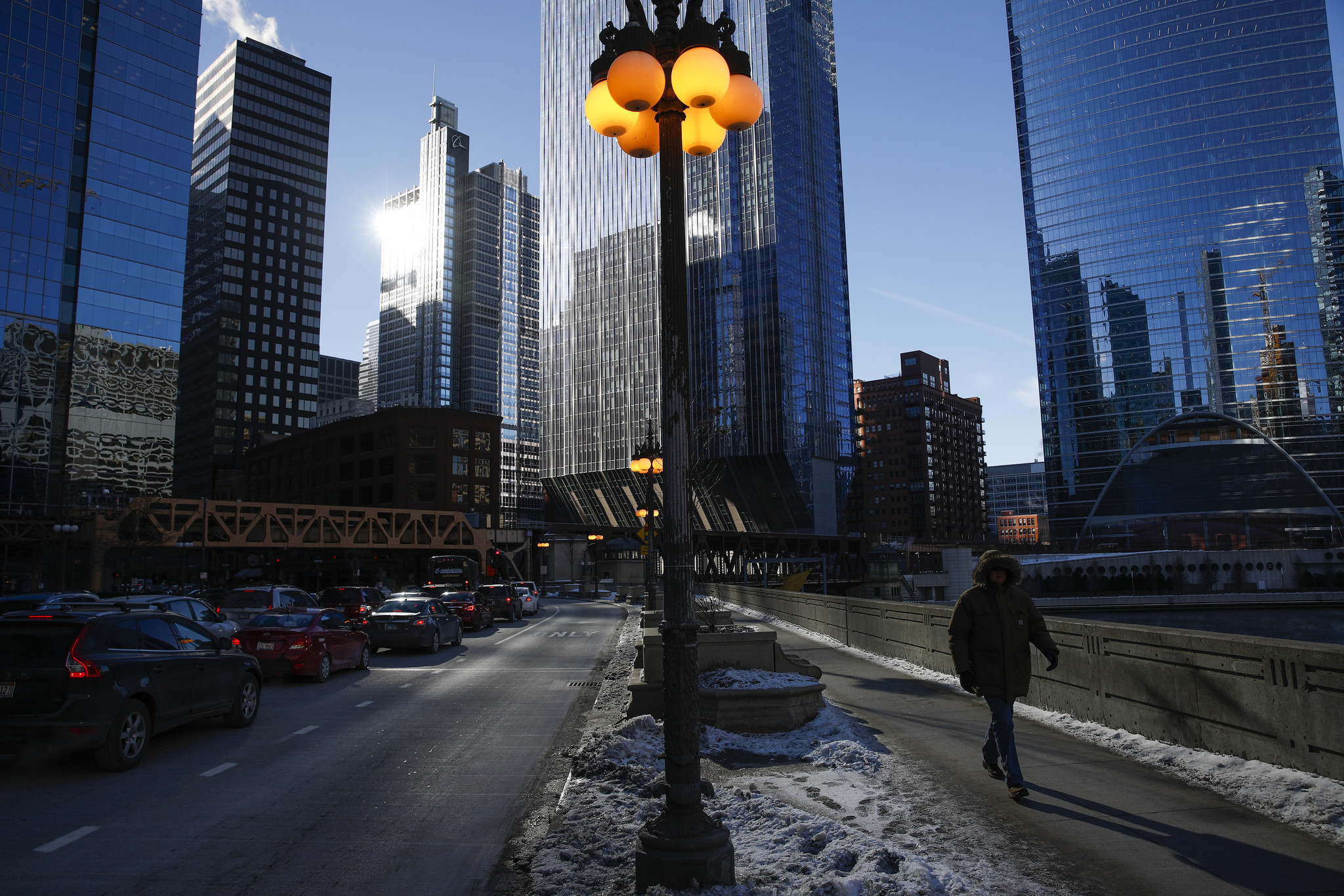 Pedestrians walk on West Wacker Drive in Chicago on a...