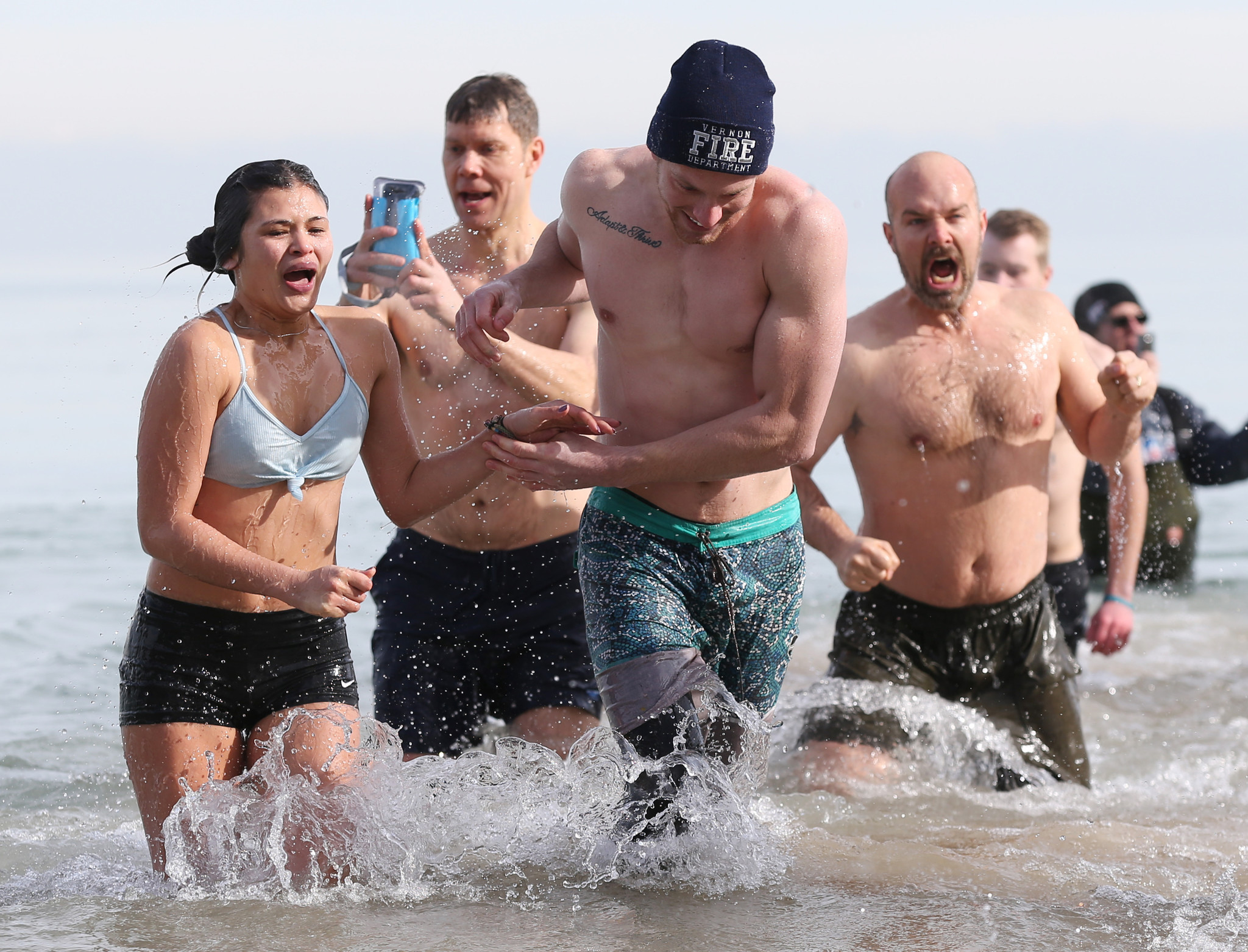 Participants run through Lake Michigan during the 18th annual Polar...
