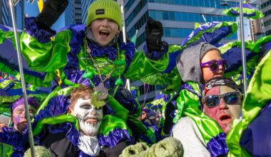 Mason McCaffrey. 11, rides on shoulder of his father Christian McCaffrey  as Froggy Carr members march during the Mummers Parade Thursday, Jan. 1, 2026. This year marks the 125th anniversary of Philly’s iconic New Year’s Day celebration. in the Mummers Parade Thursday, Jan. 1, 2026.
