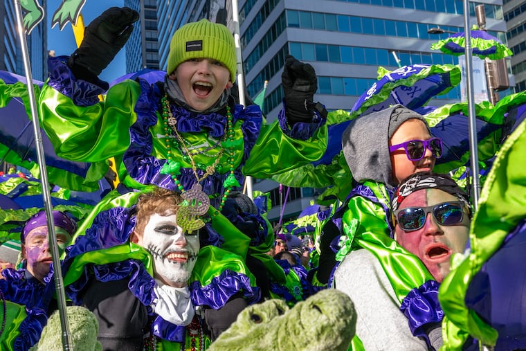 Mason McCaffrey. 11, rides on shoulder of his father Christian McCaffrey  as Froggy Carr members march during the Mummers Parade Thursday, Jan. 1, 2026. This year marks the 125th anniversary of Philly’s iconic New Year’s Day celebration. in the Mummers Parade Thursday, Jan. 1, 2026.