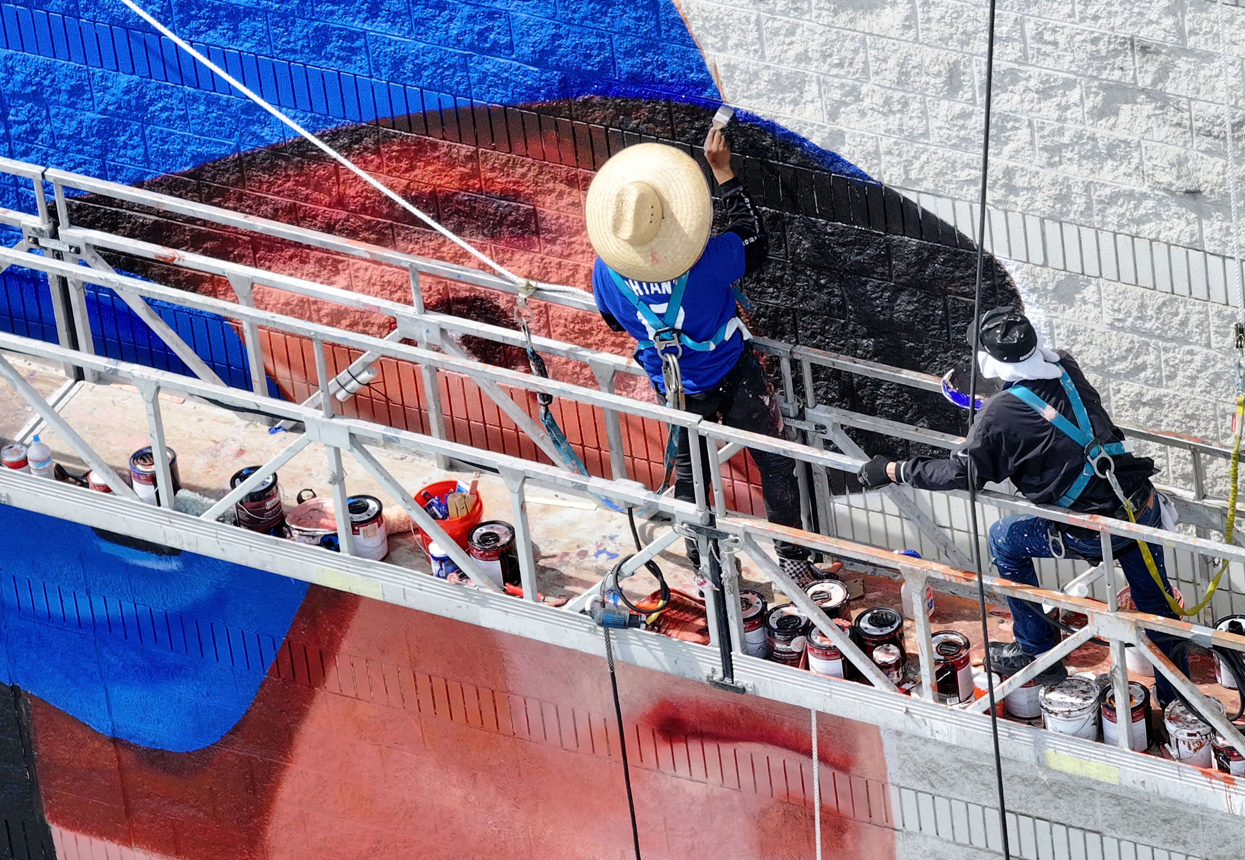 Muralist Robert Vargas works on a the Shohei Ohtani mural,...