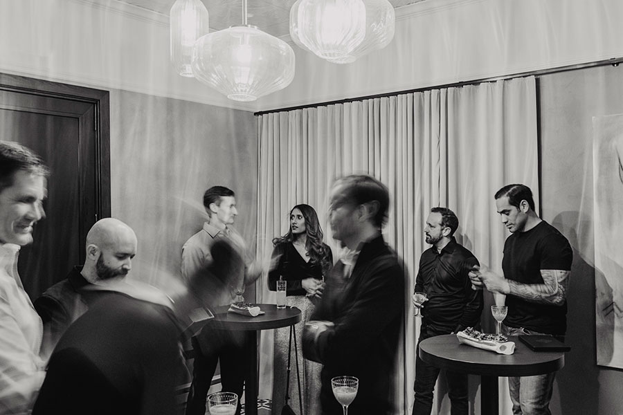 people standing around bar tables chatting