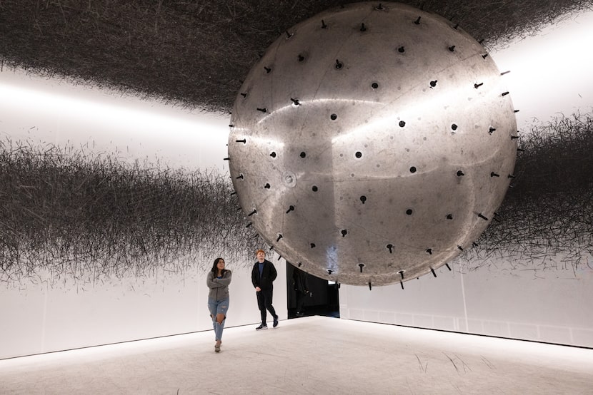 Dayanara Renteria and Dylan Stinson, of Dallas, walk around the “ADA” exhibit at the Balloon...