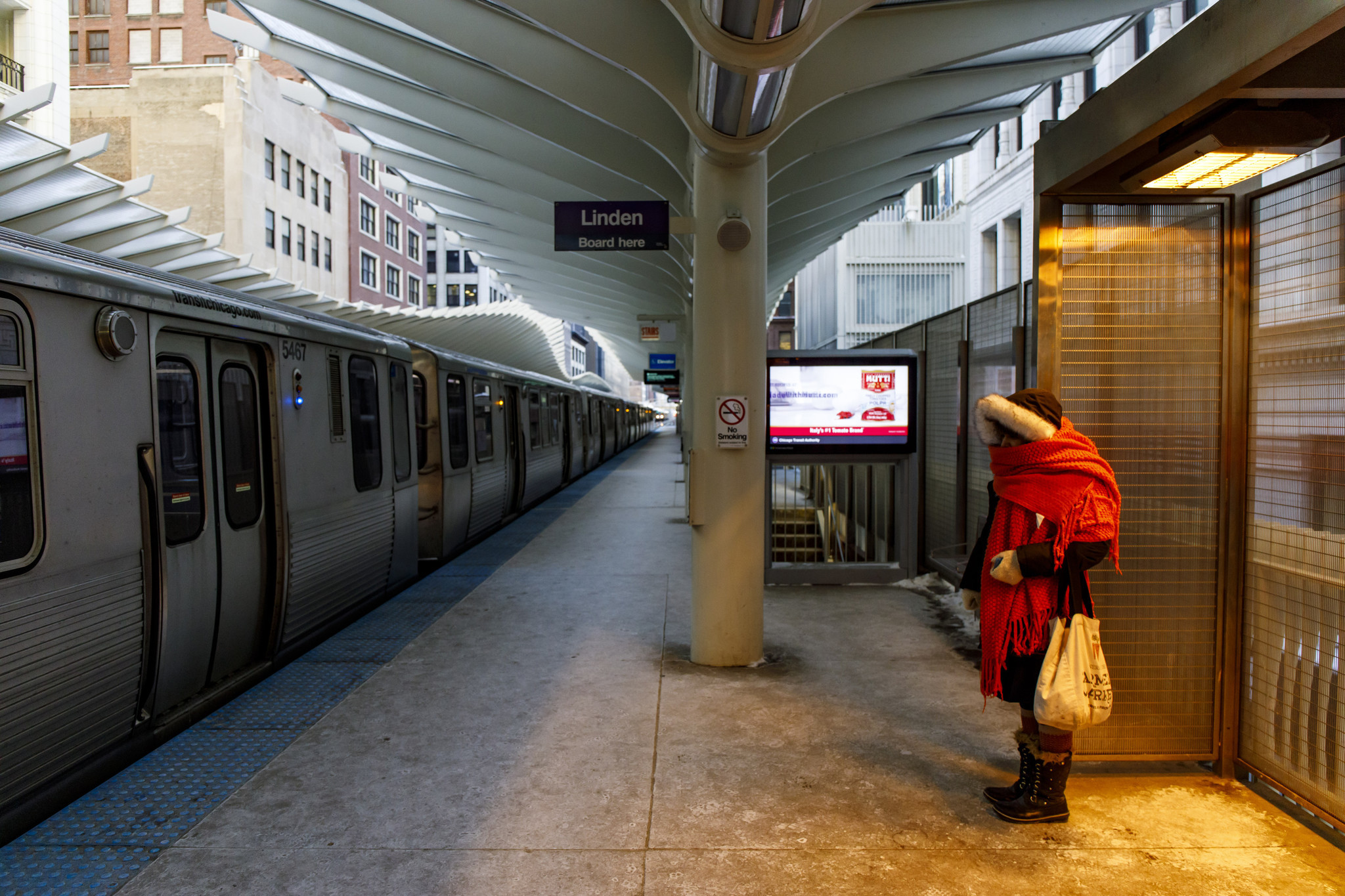 A lone woman waits for a train at the Washington...