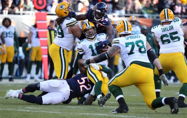 Bears linebackers Khalil Mack, No. 52, and Leonard Floyd sack Packers quarterback Aaron Rodgers in the fourth quarter on Dec. 16, 2018, at Soldier Field.