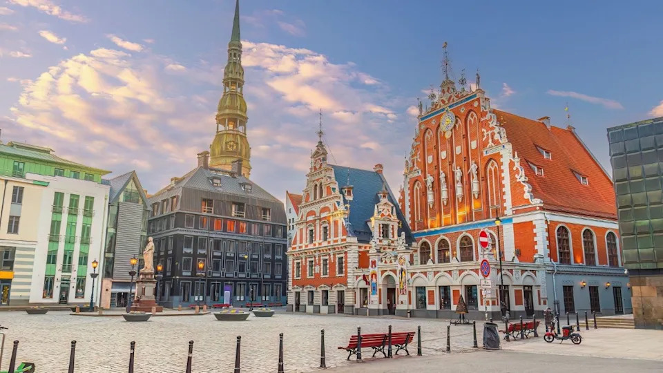 City Hall Square with House of the Blackheads and Saint Peter church in Old Town of Riga, Latvia’s capital at sunset