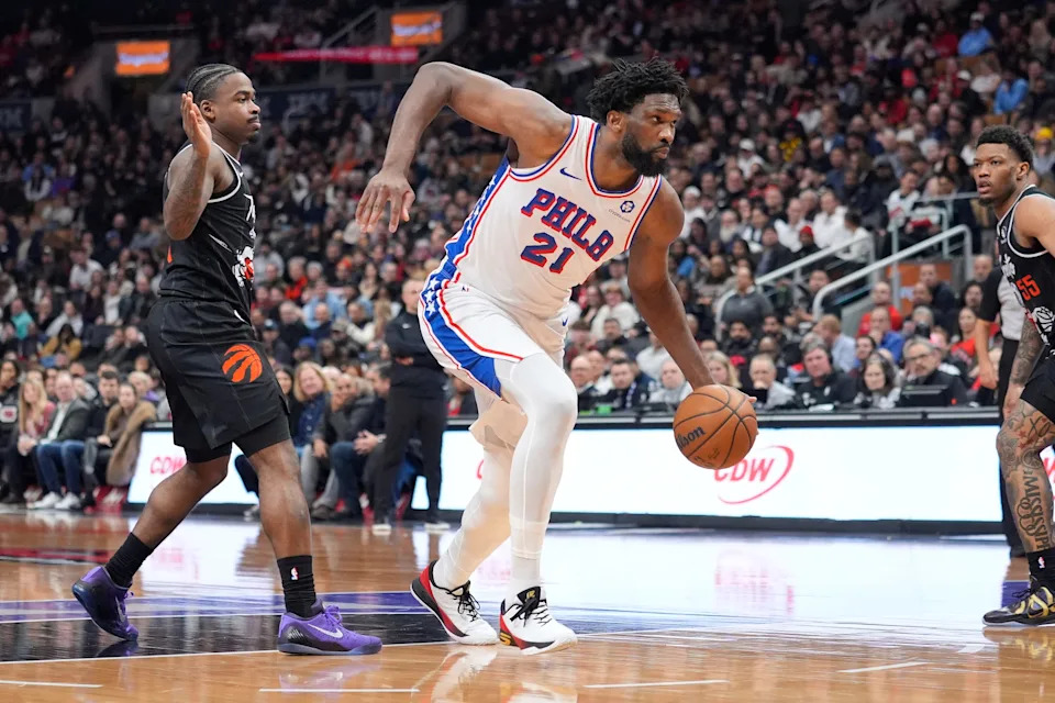 Jan 12, 2026; Toronto, Ontario, CAN; Philadelphia 76ers center Joel Embiid (21) dribbles past Toronto Raptors guard Jamal Shead (23) during the first half at Scotiabank Arena. Mandatory Credit: John E. Sokolowski-Imagn Images