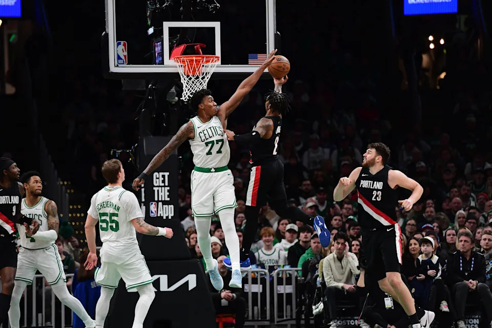 Jan 26, 2026; Boston, Massachusetts, USA; Boston Celtics forward Amari Williams (77) blocks the shot of Portland Trail Blazers guard Caleb Love (2) during the second half at TD Garden. Mandatory Credit: Bob DeChiara-Imagn Images