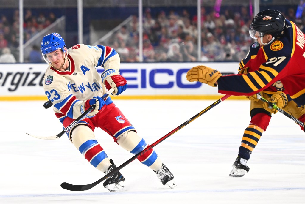 Adam Fox #23 of the New York Rangers shoots the puck into the offensive zone during the first period of the 2026 Discover NHL Winter Classic game between the New York Rangers and the Florida Panthers at loanDepot park on January 02, 2026 in Miami, Florida. 