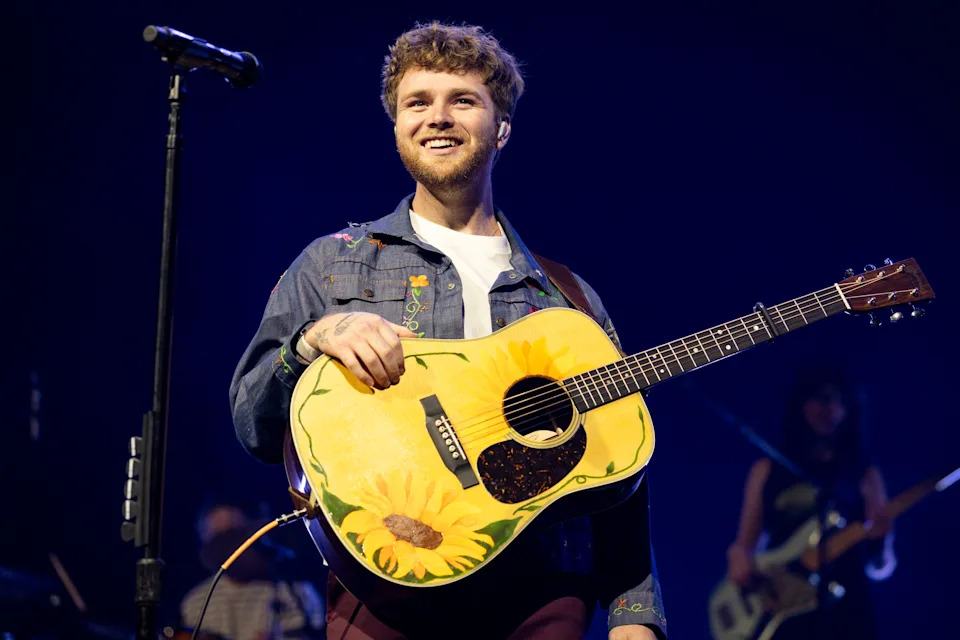 Alex Warren performs onstage.
