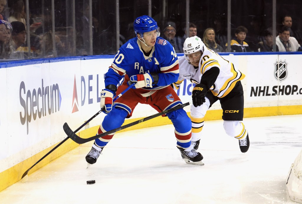 Artemi Panarin of the New York Rangers skating against the Boston Bruins during a hockey game.