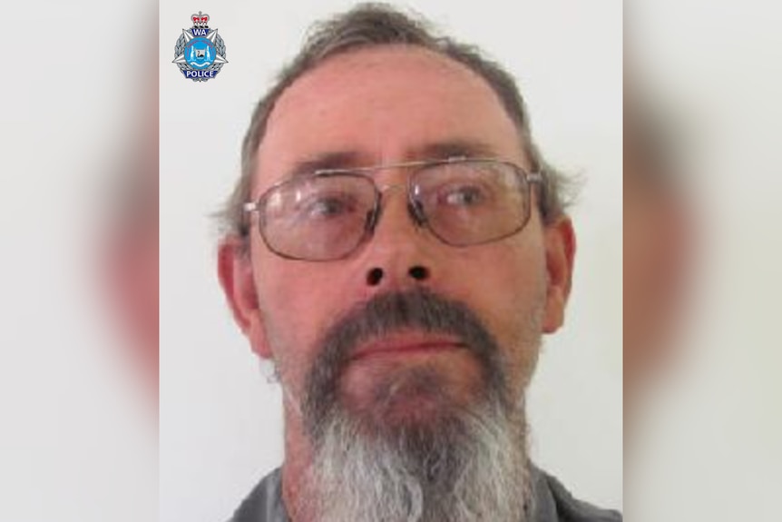 A supplied image of Kenneth John GILES, a caucasian man with wire frame glasses and a long goatee.