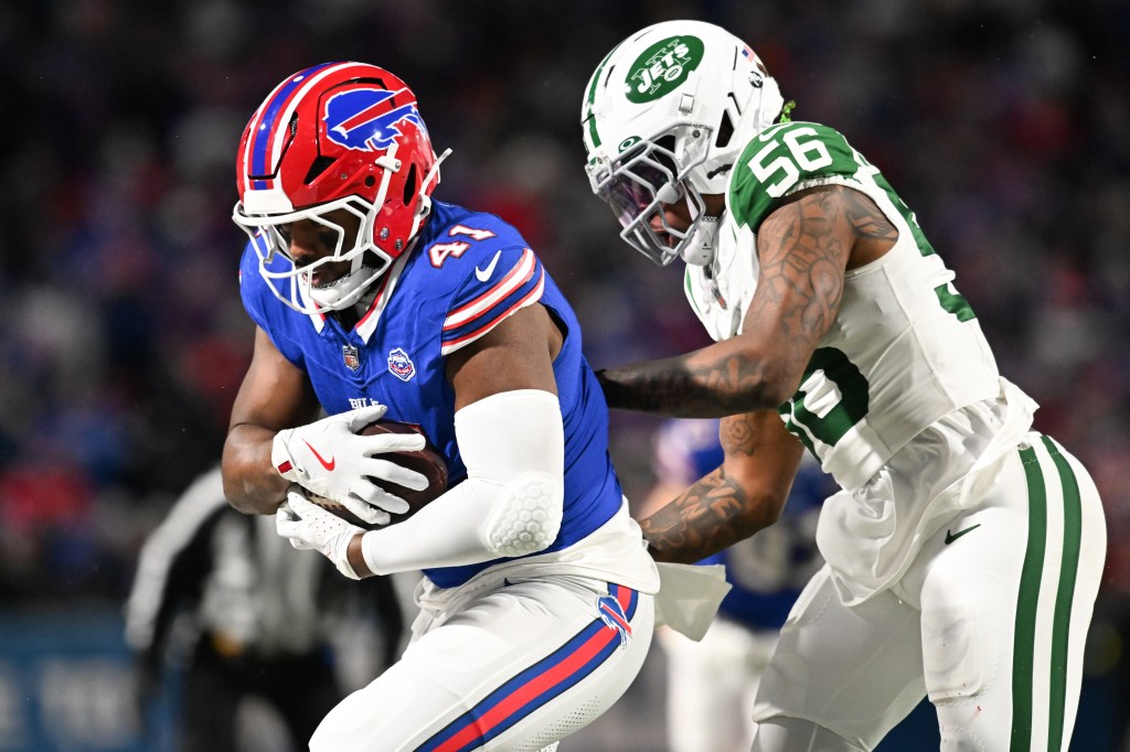 Buffalo Bills fullback Reggie Gilliam (41) carries the ball defended by New York Jets linebacker Quincy Williams (56) during the second quarter at Highmark Stadium. 