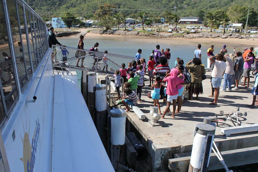 Crowds gather for a ferry docking at Palm Island