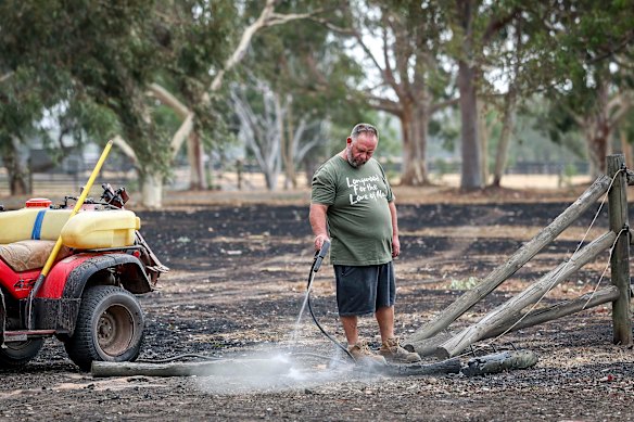Shane Peterson mopping up on Saturday after fire swept through Longwood.