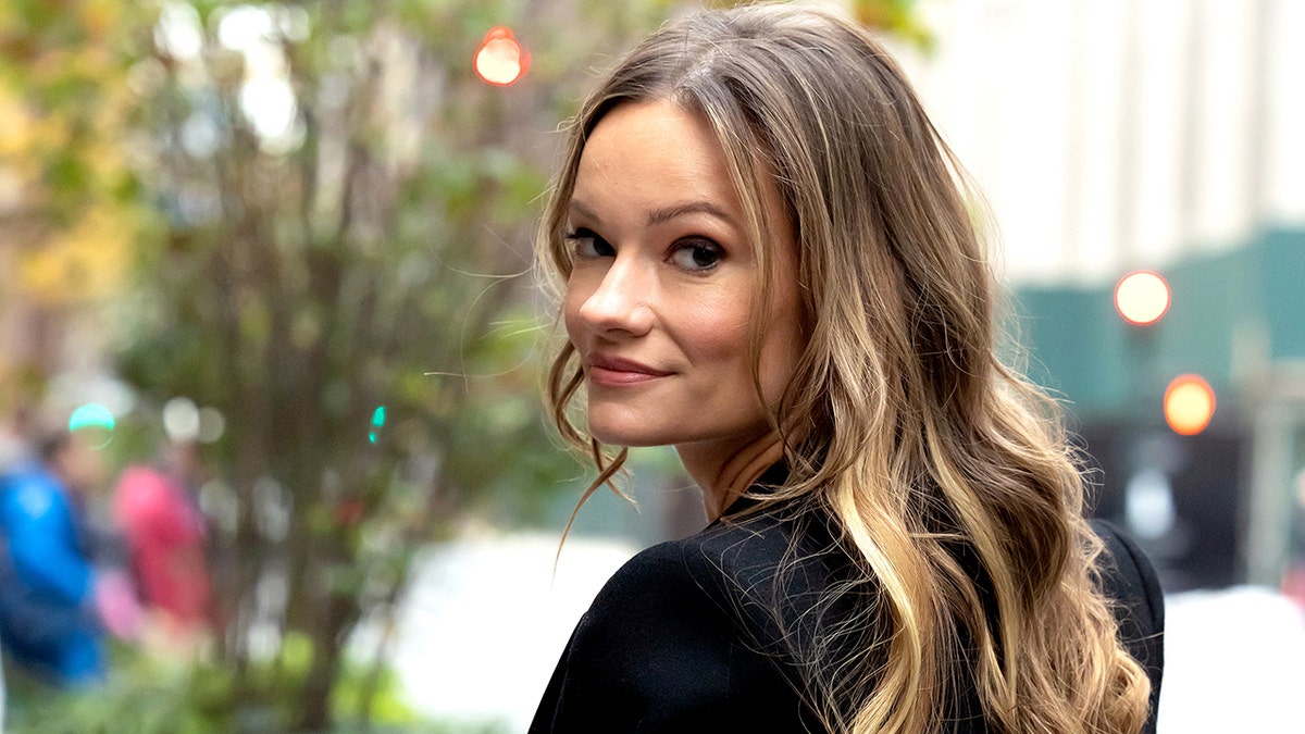 Caitlin O'Connor with her face turned looking at the camera in New York City.