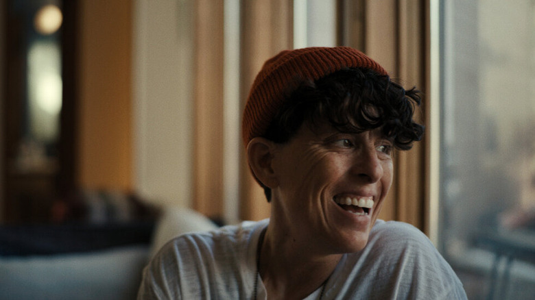 Andrea laughing in a cap in Come See Me in the Good Light