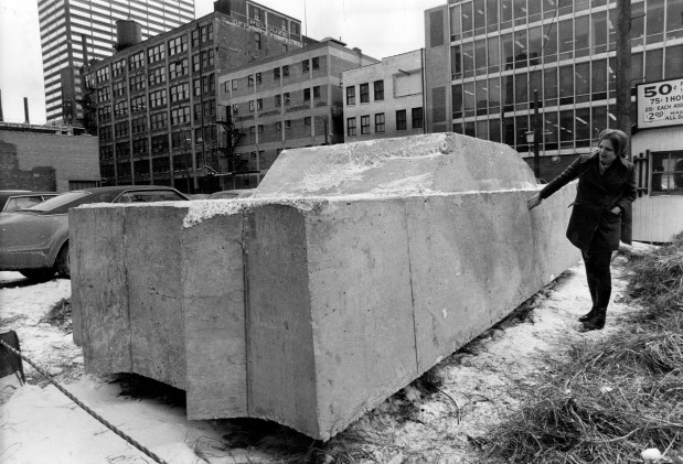 A 1957 Cadillac entombed in cement by German artist Wolf Vostell is at the Museum of Contemporary Art on Jan. 23, 1970, in Chicago. Linda Naugtin inspects the concrete car which director of the museum Jan van der Marck says "gives us a glimpse of the fantastic traffic jam in which the world may someday come to a standstill." (Don Casper/Chicago Tribune) 
