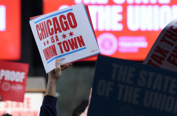 An attendee holds up a rally sign as Chicago Teachers Union President Stacy Davis Gates finishes addressing members at CTU headquarters on Jan. 27, 2026, in Chicago. (John J. Kim/Chicago Tribune)