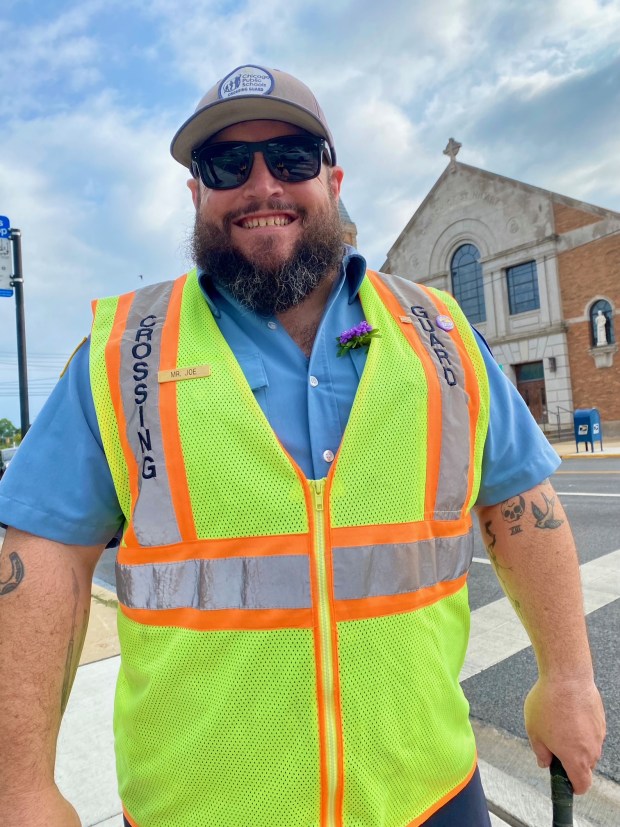 Joe Sass, a crossing guard at Jamieson Elementary School in West Ridge, was recorded by WGN News hoisting a student over his shoulder and carrying him across a slushy mess caused by a water main break on Jan. 22, 2026. (Ceridwen Sass)