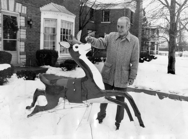 Robert L. May, 67, stands outside his home at 9515 Avers in Skokie, with one of his Rudolph the Red Nosed Reindeer on Dec. 20, 1972. (William Yates/Chicago Tribune)