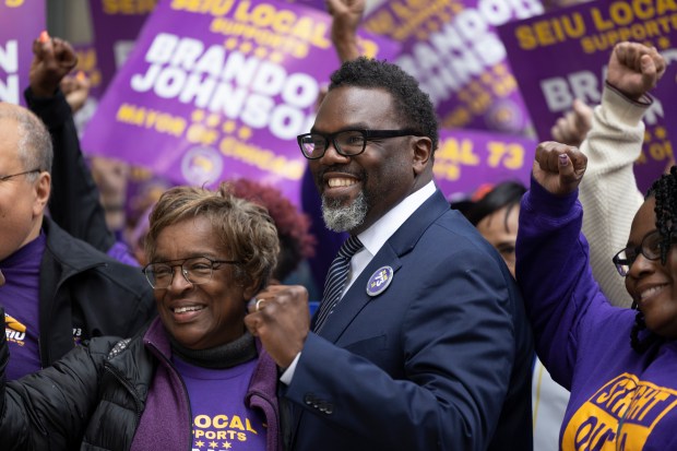 Chicago mayoral candidate Brandon Johnson greets members of SEIU Local 73 on Nov. 9, 2022, outside City Hall in Chicago. At left is SEIU Local 73 President Dian Palmer. (Erin Hooley/Chicago Tribune)