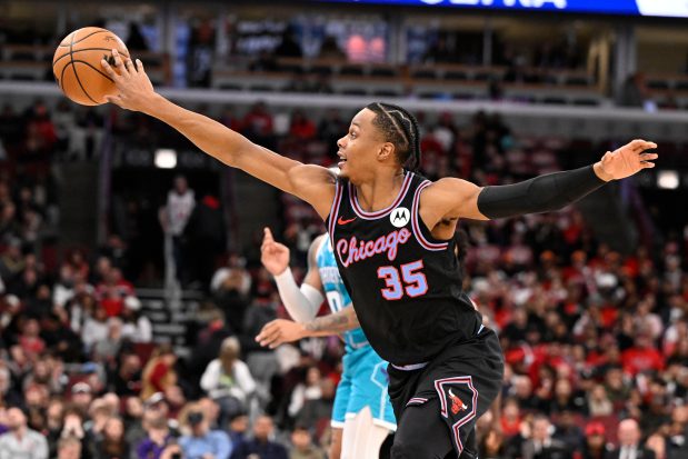 Chicago Bulls forward Isaac Okoro tips the ball against the Charlotte Hornets on Saturday, Jan. 3, 2026, in Chicago. (AP Photo/Matt Marton)