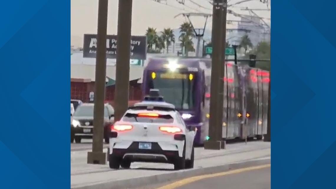 Waymo car seen driving on light rail tracks in Phoenix