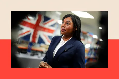 PA Kemi Badenoch with a Union Jack flag in the background