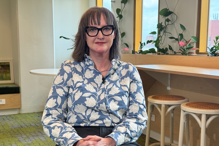 Juliet looks at the camera with a serious expression on her face.