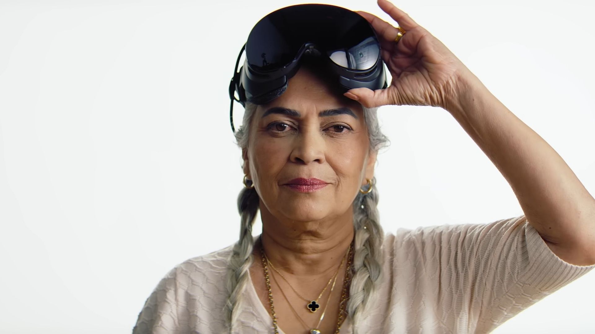 A woman lifting up the Steam Frame from her face