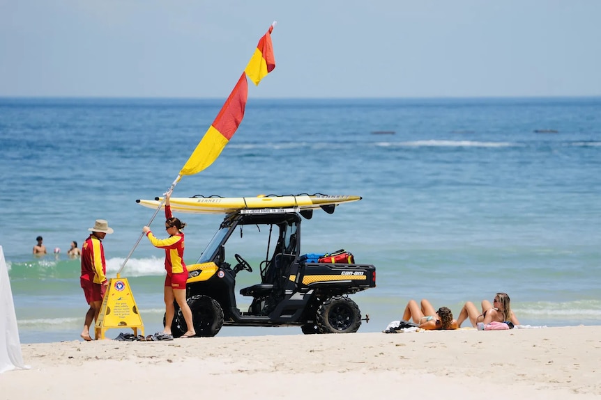 People lie down on a beach in South Australia.
