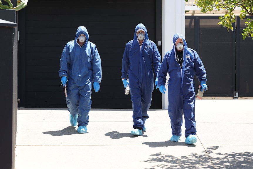 Police are at the front yard of a house