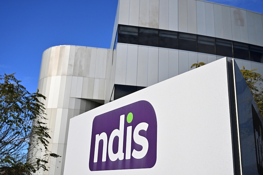 The exterior of a building with NDIS signage prominently displayed on the outside. Location is not specific.