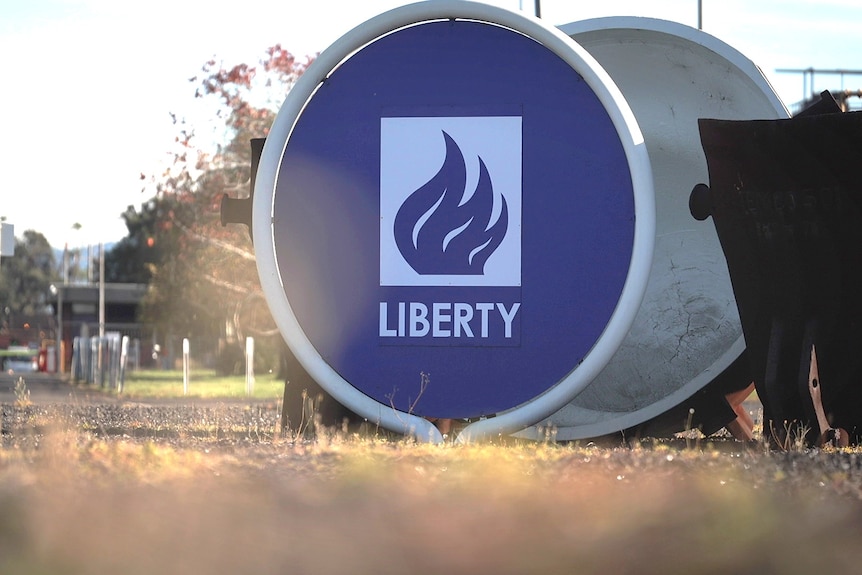Large round purple sign with the word Liberty and a picture of fire.